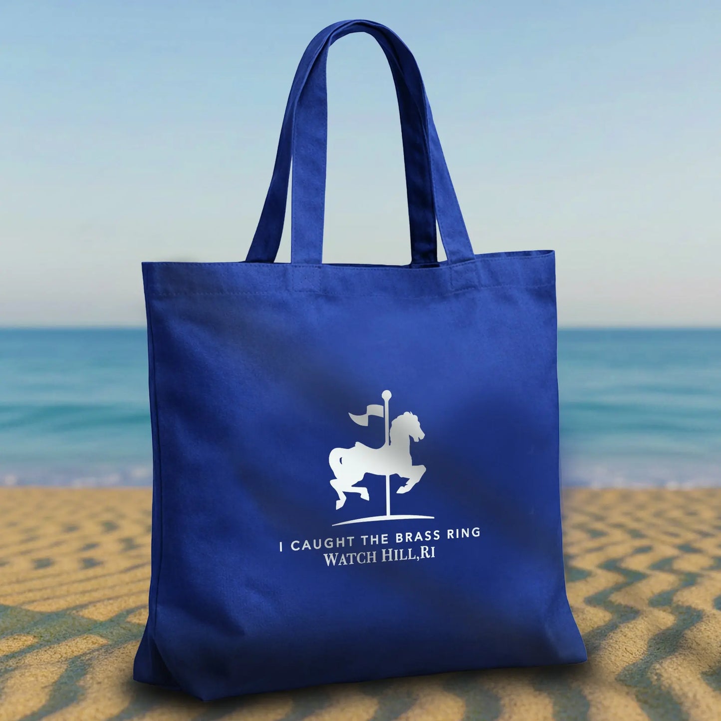 Featuring the beloved carousel emblem in crisp white against rich navy blue. SHOP Now at The Wishful Fish