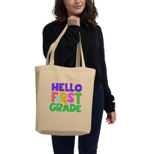 Load image into Gallery viewer, HELLO FIRST GRADE Eco Tote Bag for Teachers | Oyster | 16&quot; x 14.5&quot; | Front View Lifestyle Photo | Shop The Wishful Fish
